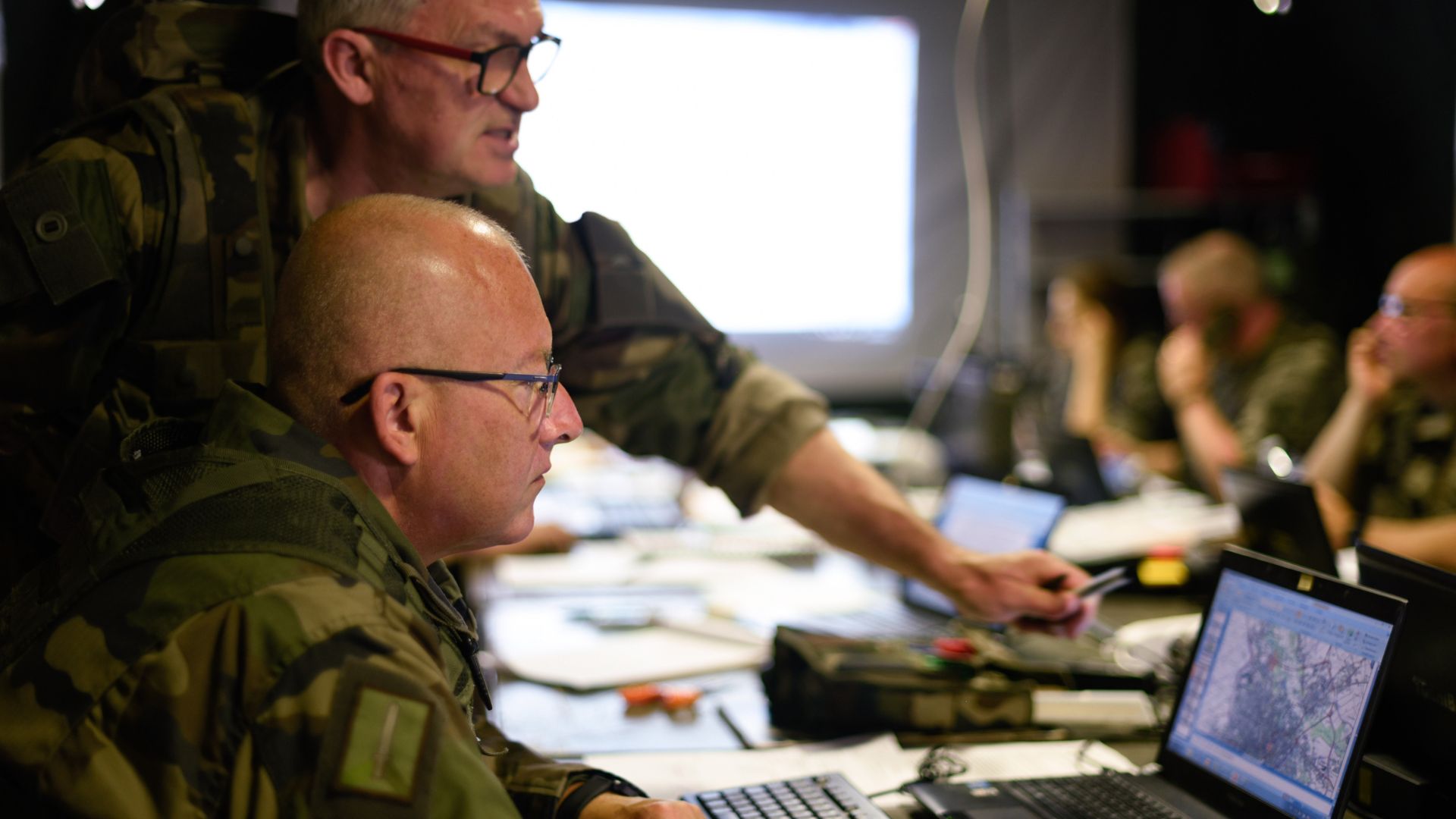 Le lieutenant réserviste pointe du doigt une position sur le carte de son camarade lors de l'exercice Bablon.